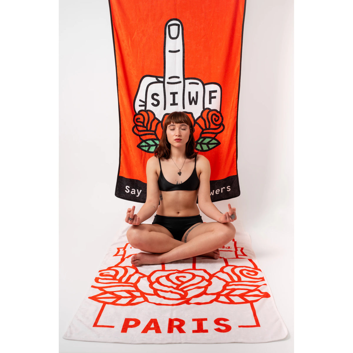 SIWF white beach towel with a red raised middle finger and roses emblem