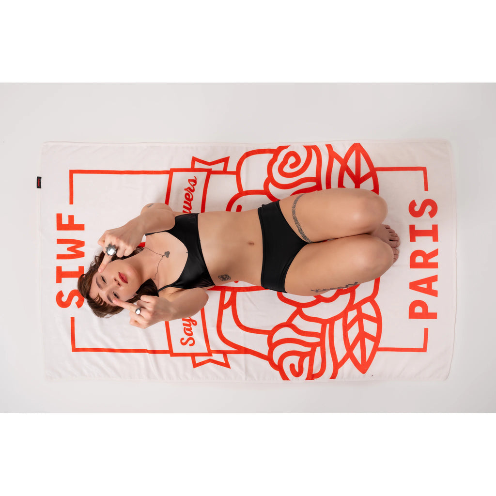 SIWF white beach towel with a red raised middle finger and roses emblem