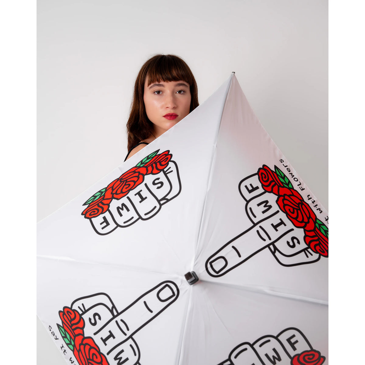SIWF square white umbrella printed with a raised middle finger and red roses